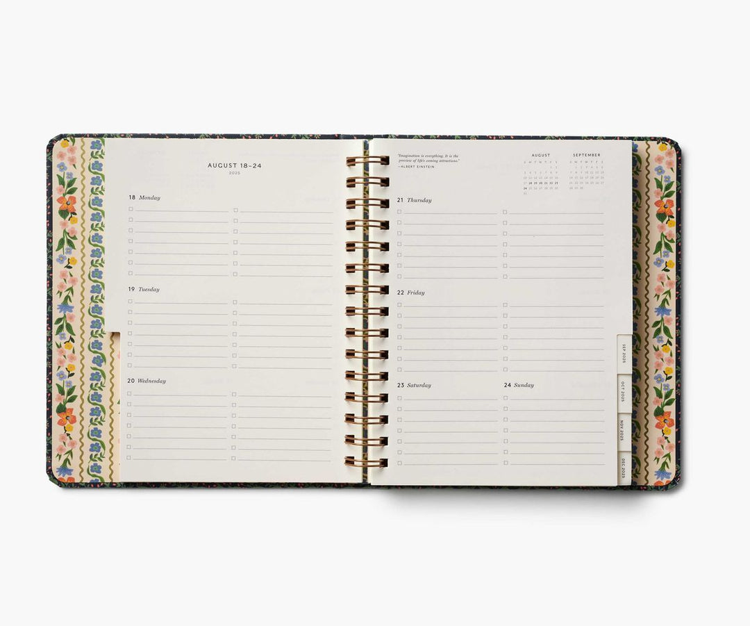 Open planner with floral design on a white background