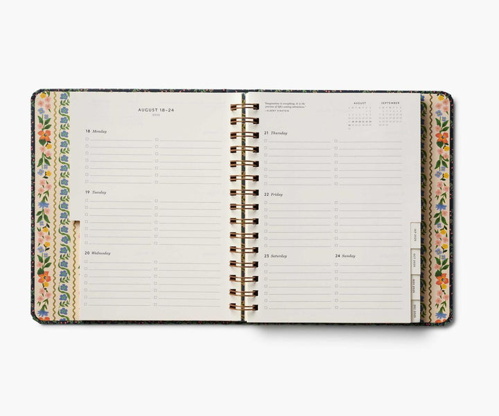 Open planner with floral design on a white background
