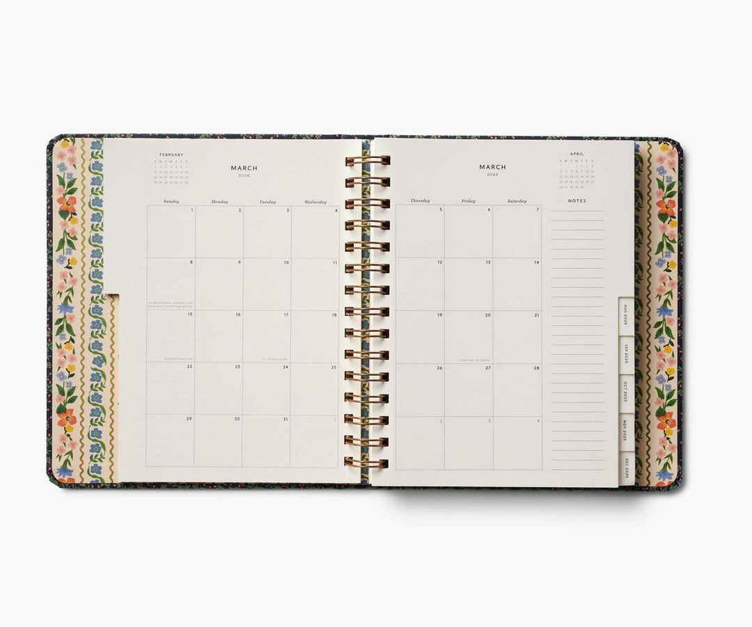 Spiral-bound planner with floral borders on a white background