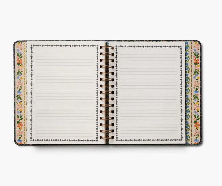 Notebook with floral design on the cover and side, on a white background