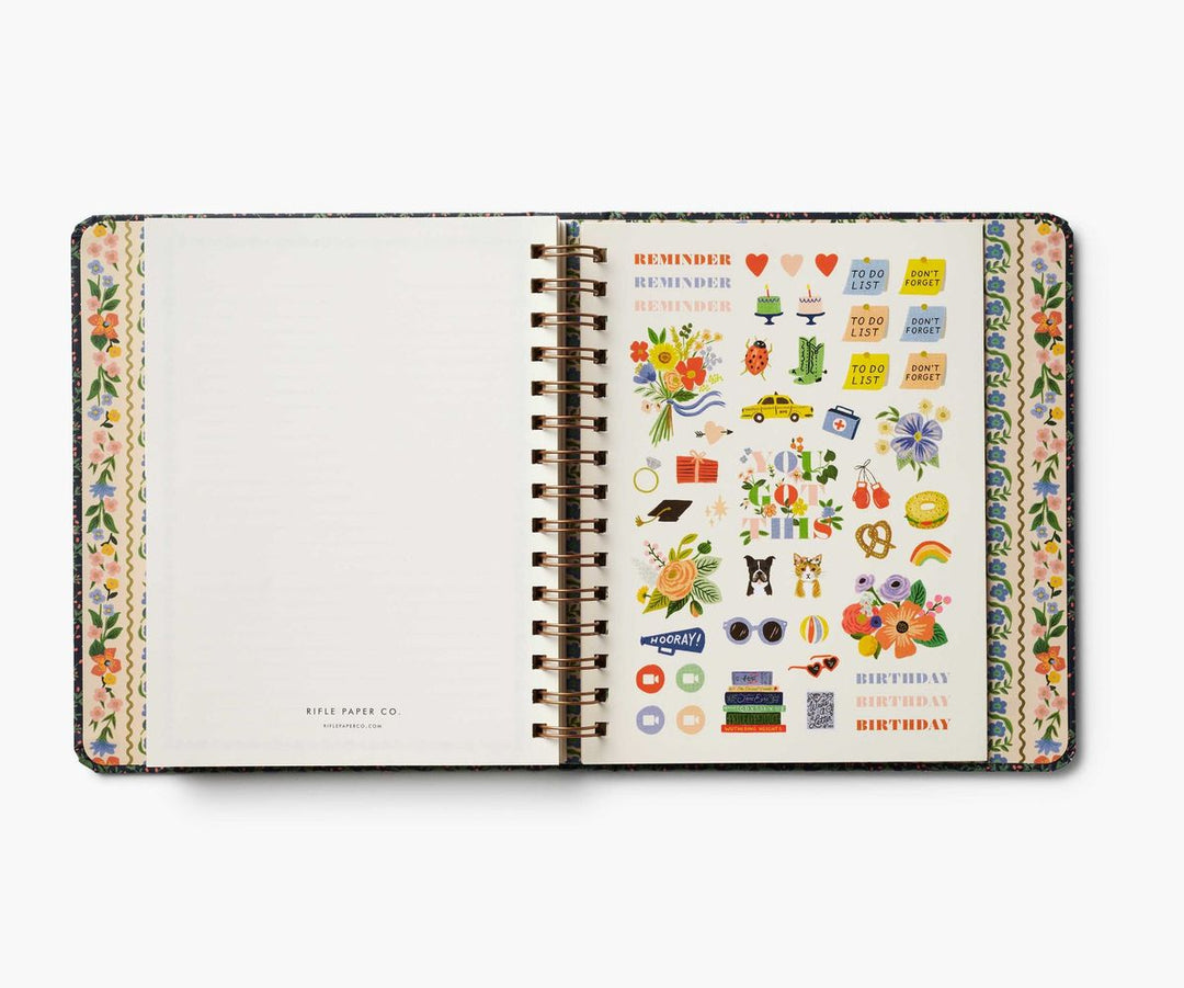 Open planner with decorative stickers on a white background