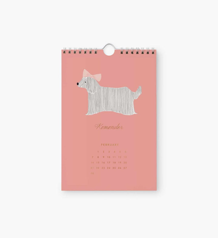 Pink spiral-bound calendar with a dog illustration on a white background