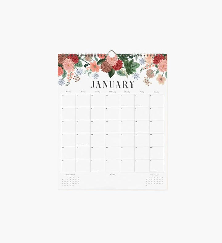 A single-page January desk calendar with a floral border at the top, shown hanging against a plain light background.