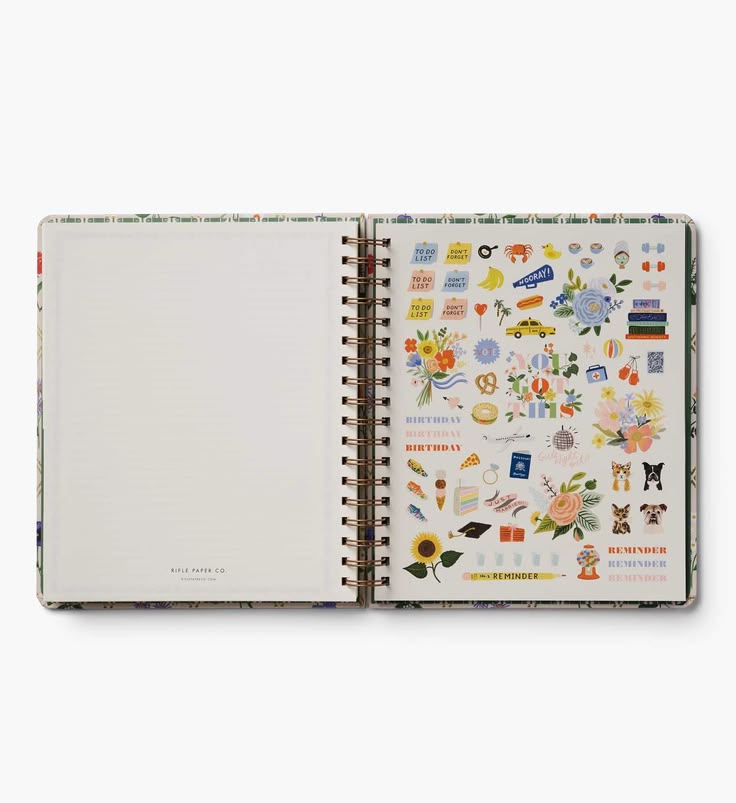 An open spiral-bound planner or notebook showing a decorated sticker sheet on the right page with colorful birthday-themed illustrations, set against a clean white background.