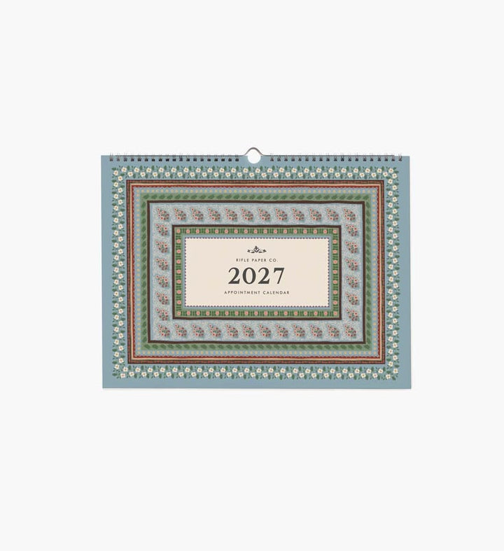 A 2027 wall calendar with a sage green background, white floral pattern, and a dark burgundy central label, shown against a plain white background.