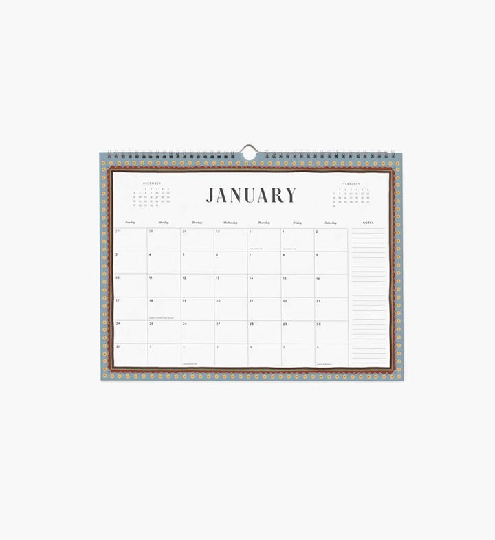 A single-page January desk calendar with a floral border at the top, shown hanging against a plain light background.