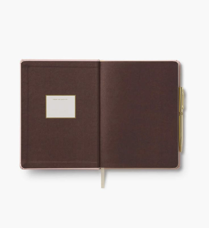 Brown notebook with a gold pen on a white background