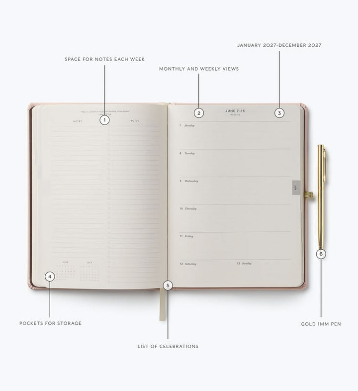 Open planner with a pen on a white background