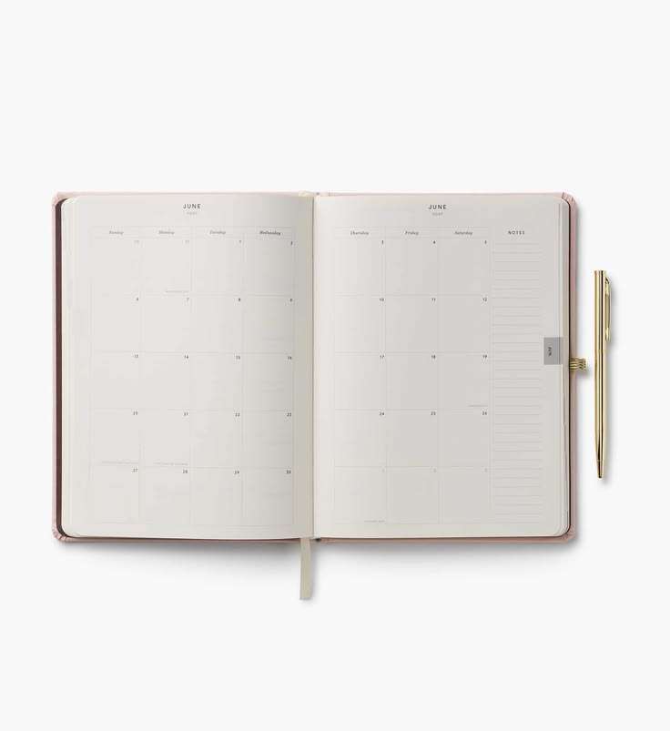 An open monthly planner with cream-colored pages and a slim gold pen resting on the right side, set against a clean white background.