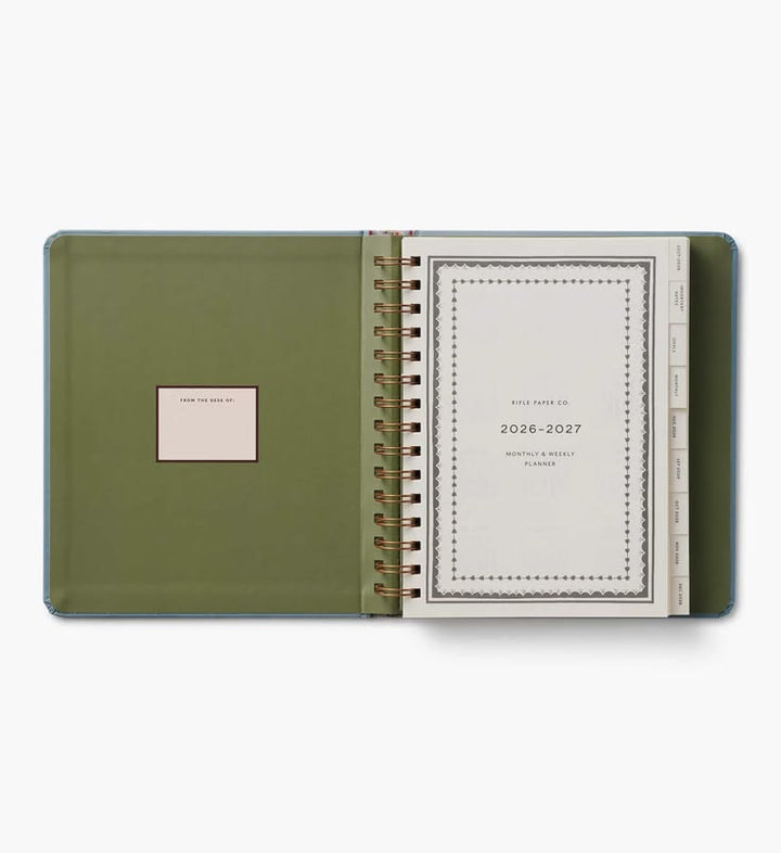 Green planner with a white interior on a white background