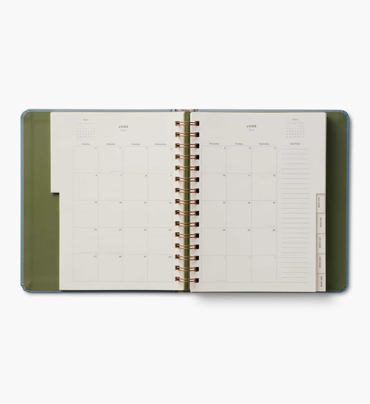 An open spiral-bound planner or calendar showing June and July monthly layouts, with an olive green cover and gold-toned spiral binding on a light gray background.