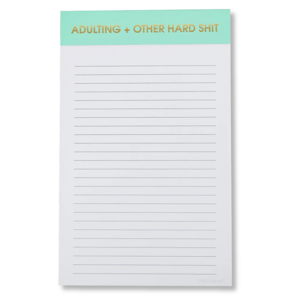 Notepad with text 'ADULTING + OTHER HARD SHIT' on a green header