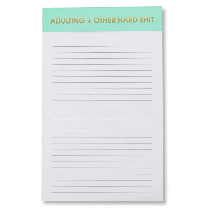 Notepad with text 'ADULTING + OTHER HARD SHIT' on a green header