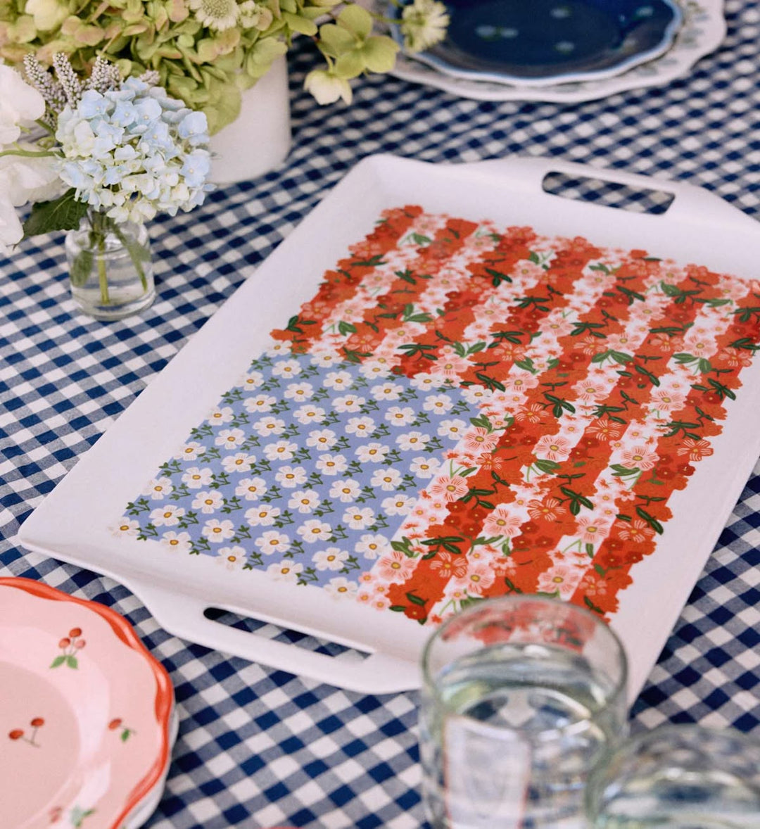 Decorative tray with floral pattern on a checkered tablecloth