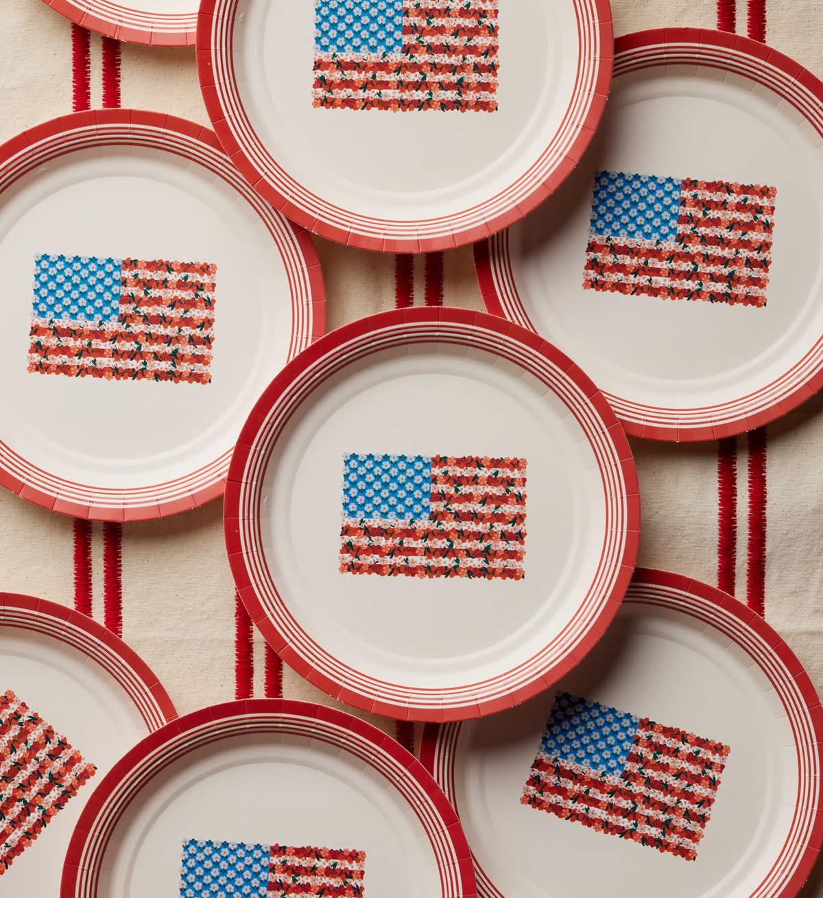 Stack of paper plates with American flag pattern on a textured surface