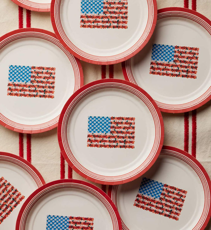 Stack of paper plates with American flag pattern on a textured surface