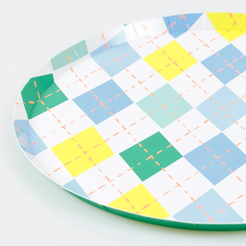 Colorful geometric-patterned paper plate on a white background