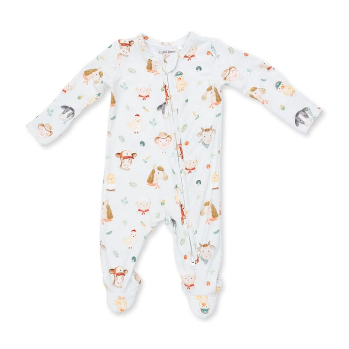 A baby footed sleeper in a very light blue color, featuring an all-over print of woodland animals including deer, squirrels, and a fox, along with small trees and leaves. The sleeper has long sleeves, a front zipper closure, and is photographed flat against a solid white background.