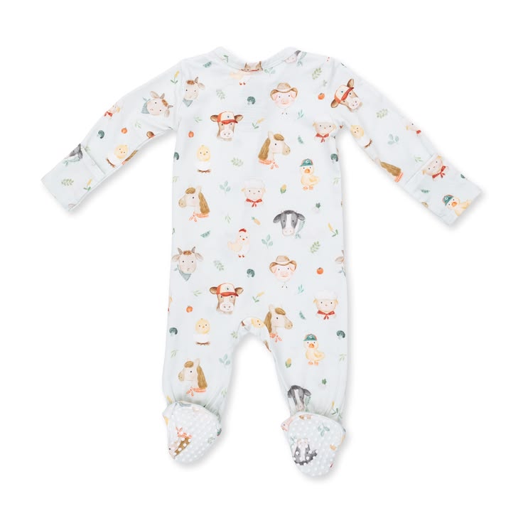 A baby long-sleeve footed sleeper in white with a colorful cartoon animal print, laid flat on a white background.