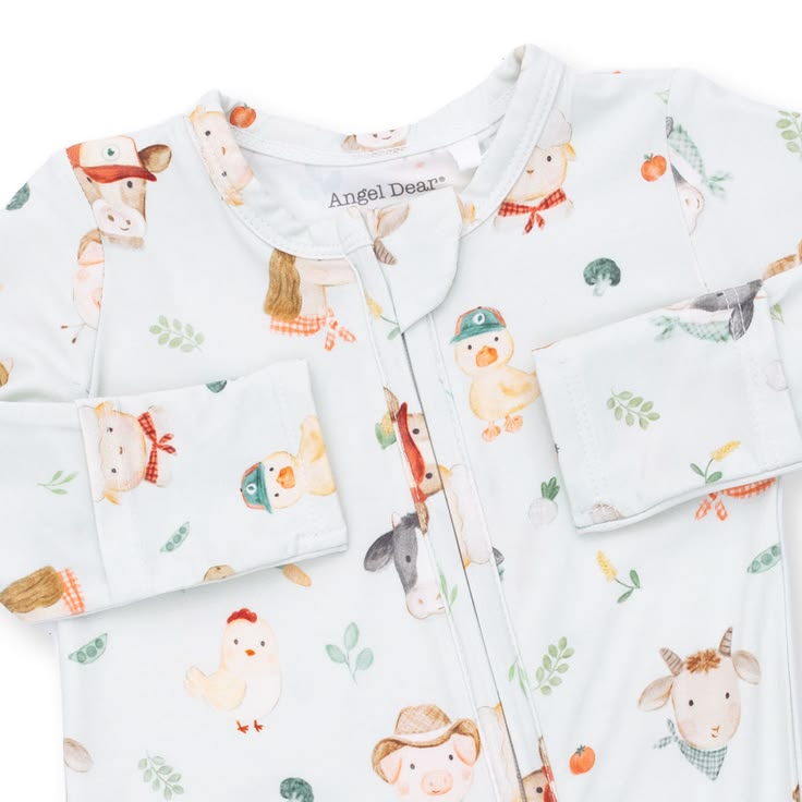 A close-up of a baby's long-sleeve zip-up pajama top by Angel Dear, featuring a white base with a colorful cartoon animal print including a duck, chicken, goat, cow, and duckling.