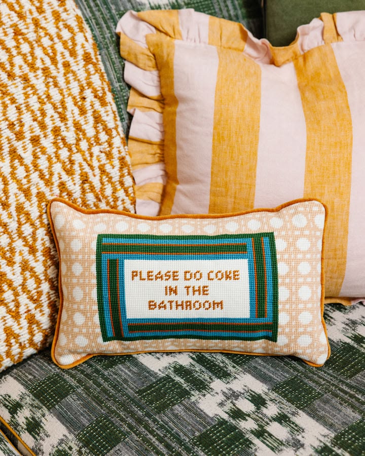 Decorative pillow with text on a patterned surface