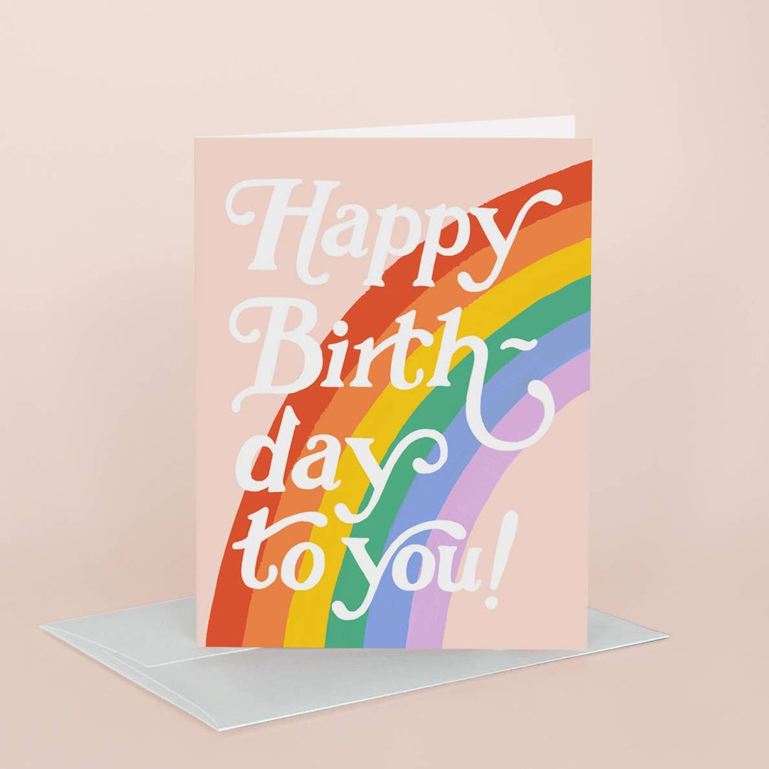 Birthday card with rainbow design and 'Happy Birthday to you!' text on a beige background