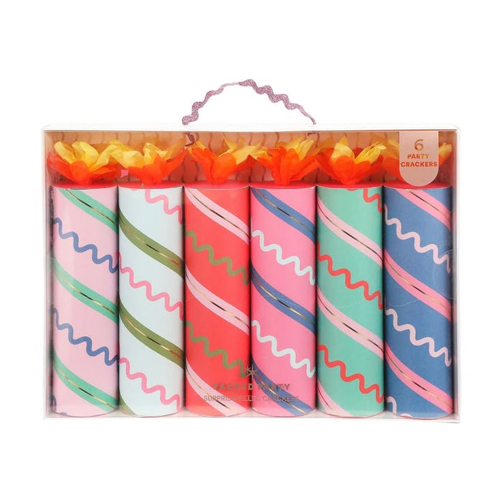Set of six colorful party crackers in packaging with decorative paper.
