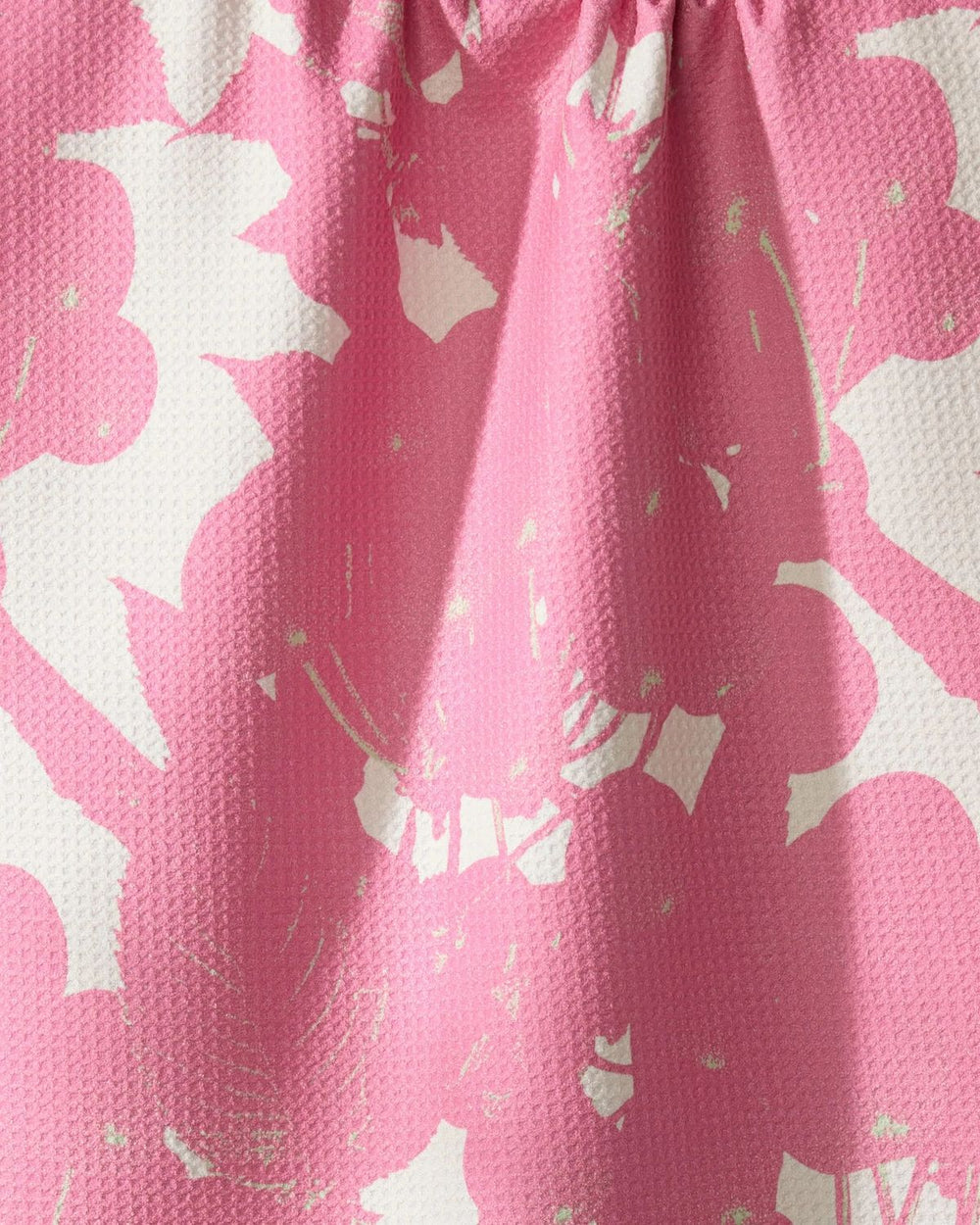 Close-up of pink fabric with white floral pattern