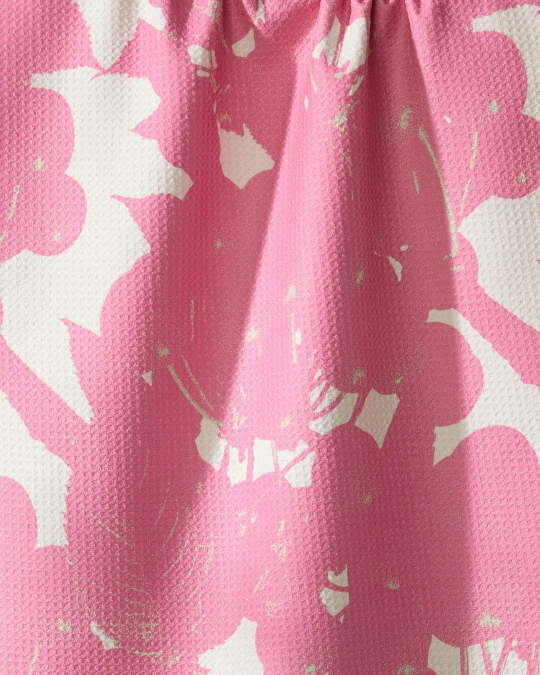 Close-up of pink fabric with white floral pattern