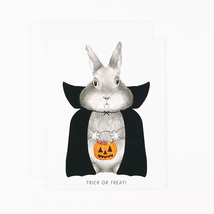A white greeting card featuring a black and white illustration of a rabbit dressed in a vampire cape and holding an orange jack-o'-lantern bucket. The text 'TRICK OR TREAT!' is printed below the illustration.