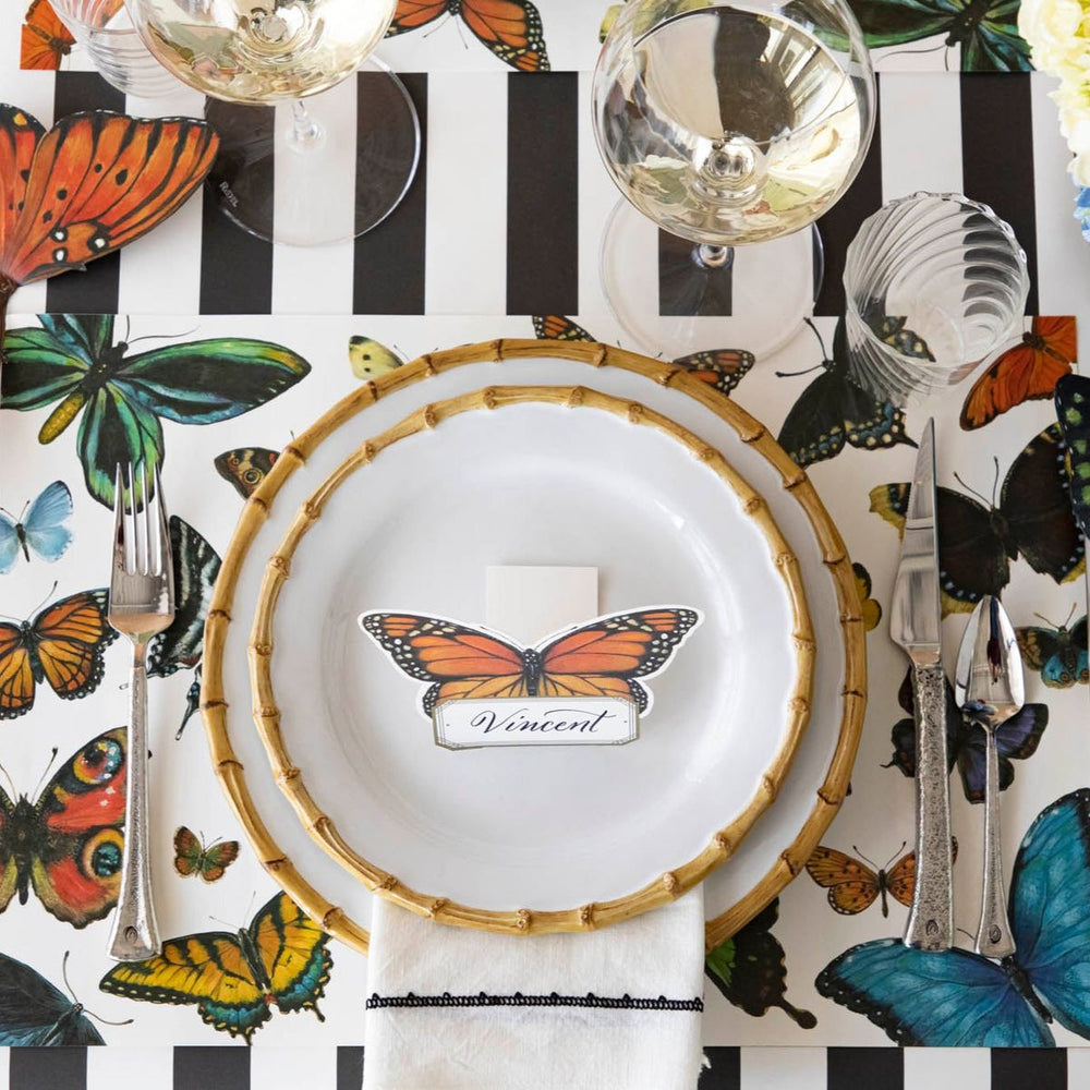 Butterfly-themed table setting with decorative placemats and cutlery.