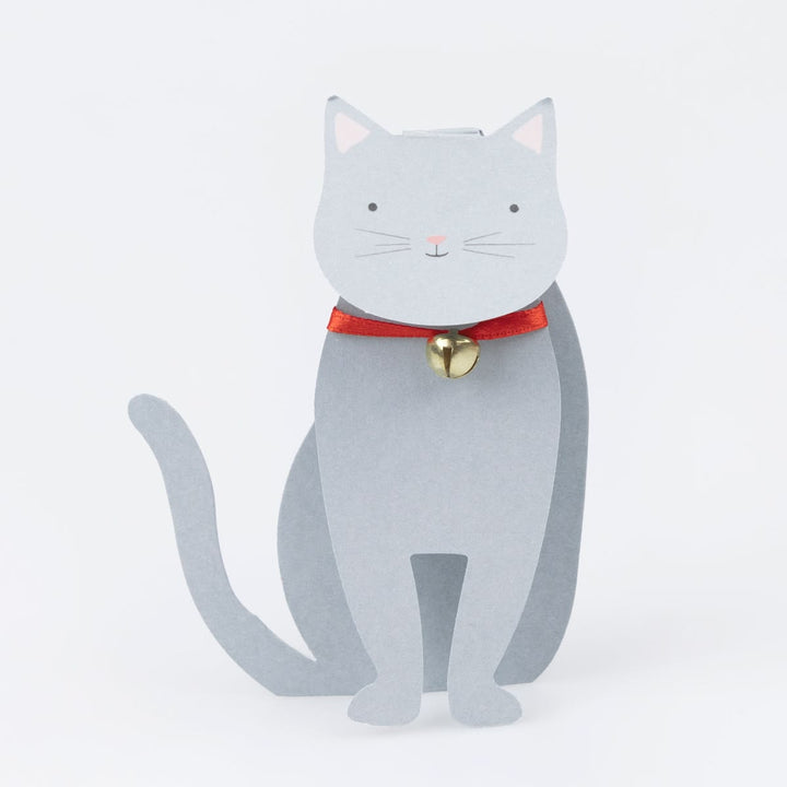 Gray cat-shaped doorstop with a red collar and gold bell on a white background