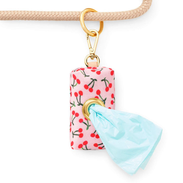 Keychain with cherry pattern and blue triangle charm on a white background
