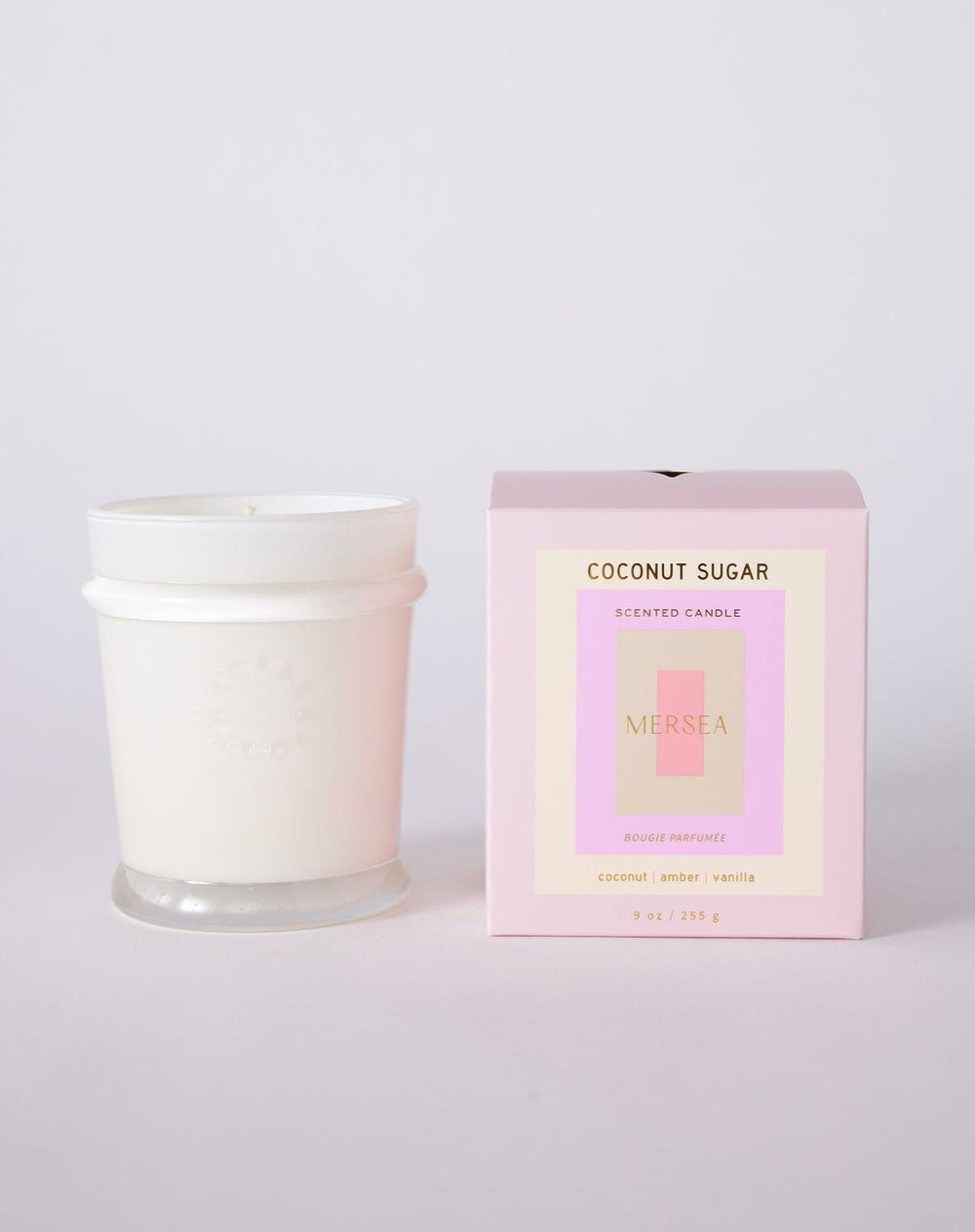 Candle and its packaging labeled 'Coconut Sugar' on a light gray background