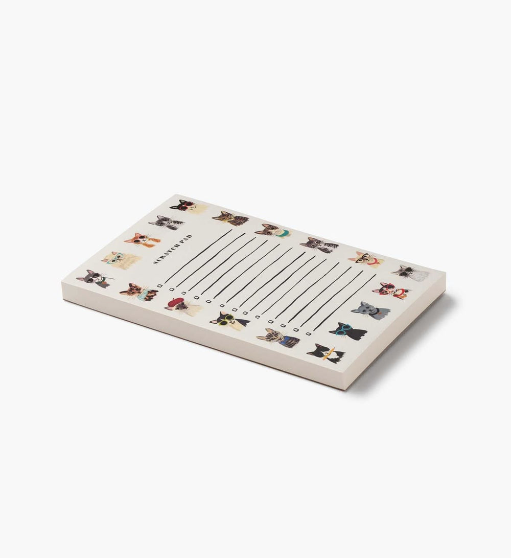 A rectangular notepad with a cream-colored cover featuring a grid of small illustrated cats and the title 'Cats of London'.