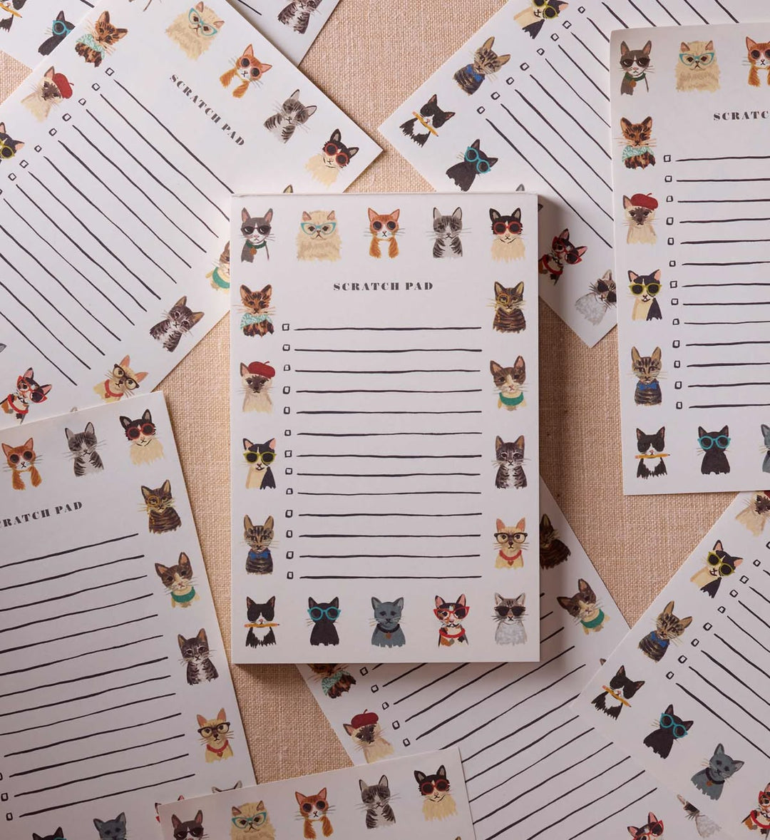 Scratch pads with cat illustrations on a textured surface