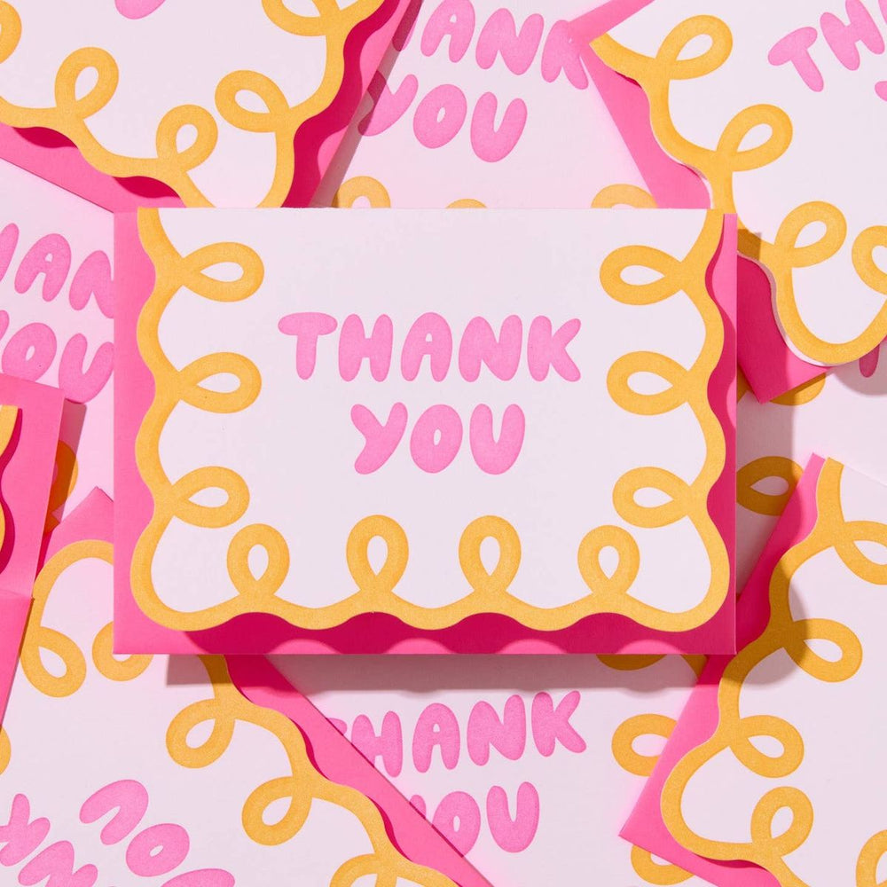 Pink and yellow 'Thank You' cards on a matching background