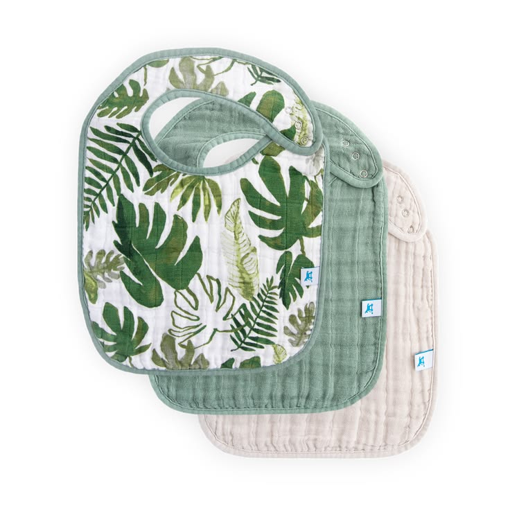 Two baby bibs with green leaf pattern and plain white sides on a white background