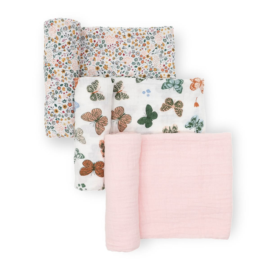 Set of four fabric swatches with floral, butterfly, and pink designs on a white background