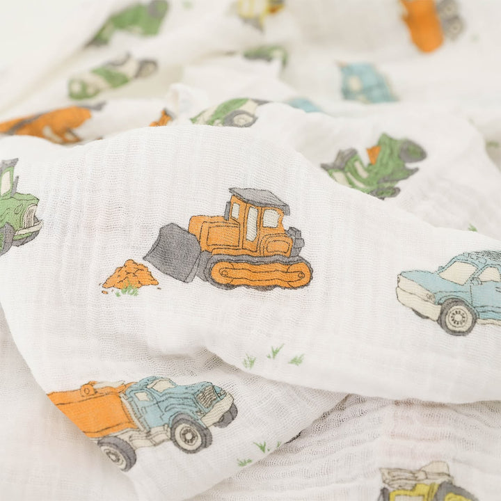 Baby blanket with construction vehicle pattern on a white background