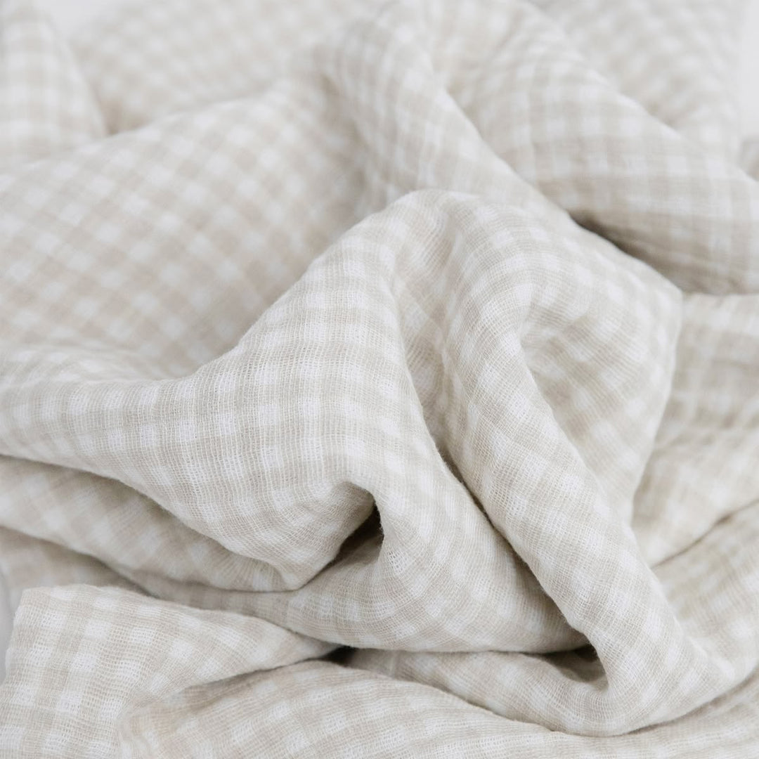 Close-up of beige textured fabric with folds