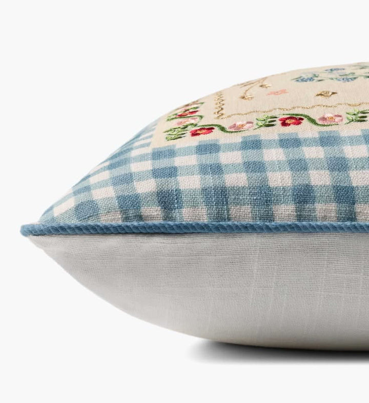 Decorative pillow with blue and white checkered pattern and floral embroidery on a white background
