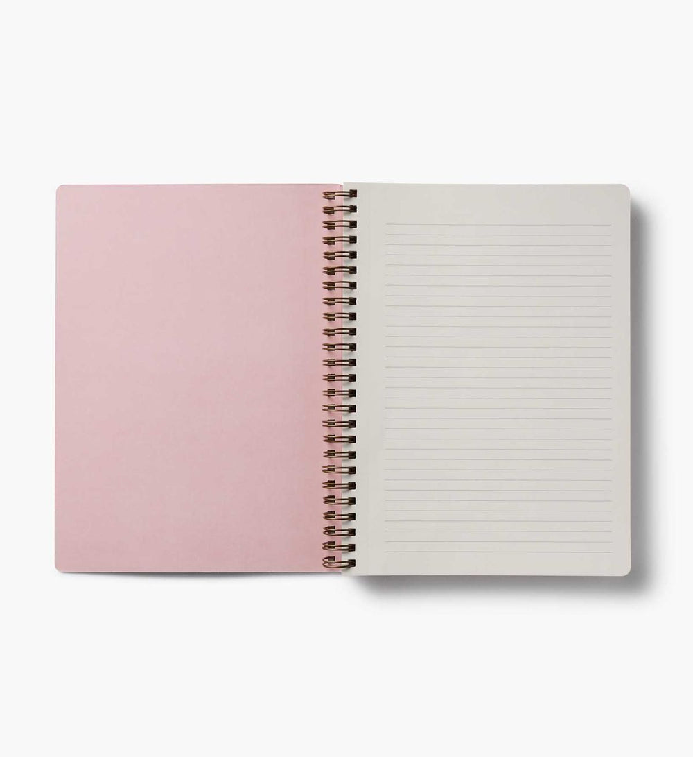 Open notebook with pink cover and white lined pages on a white background