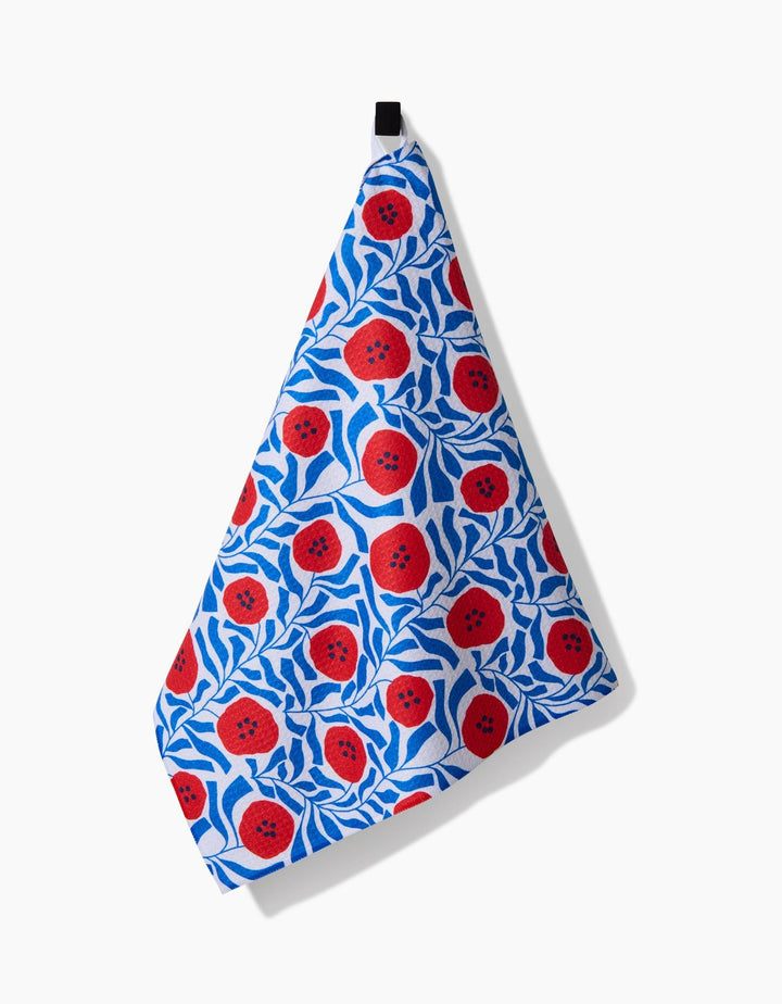 Decorative towel with red floral pattern on a white background