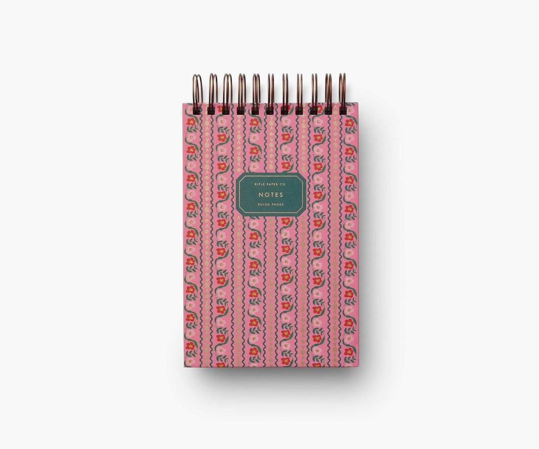 Pink notebook with a patterned cover on a white background