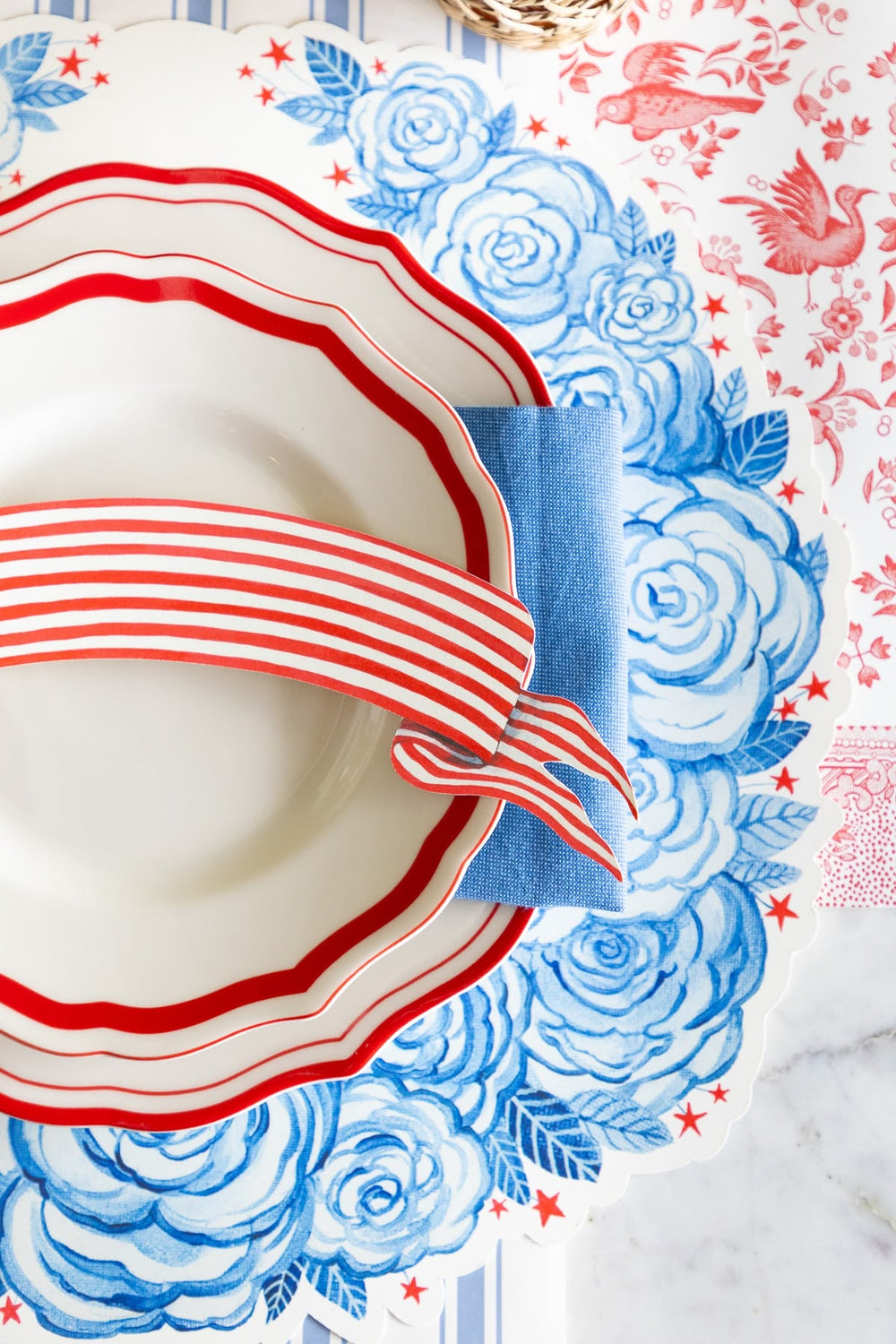 Decorative plate with red and white stripes on a floral patterned background