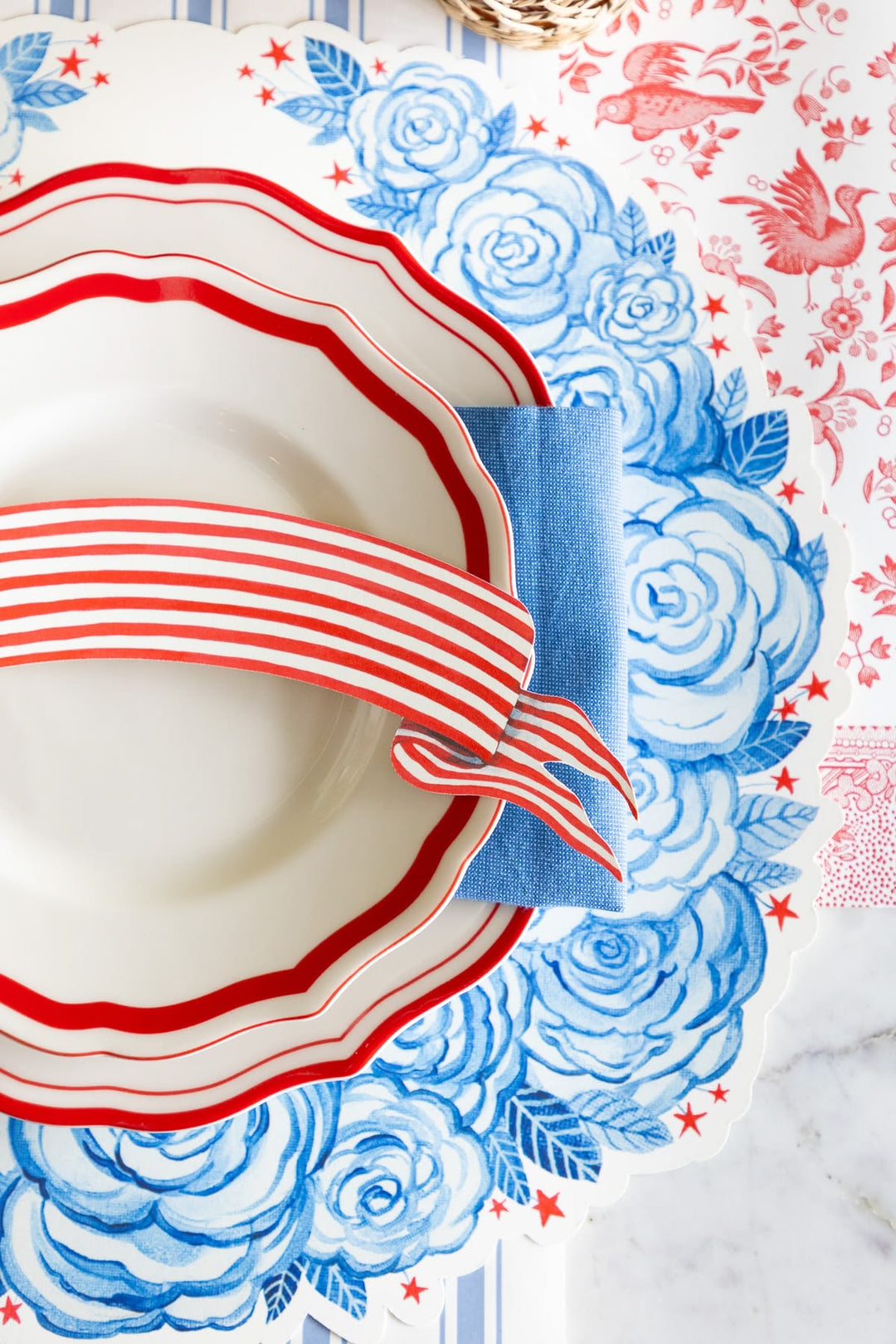 Decorative plate with red and white stripes on a floral patterned background