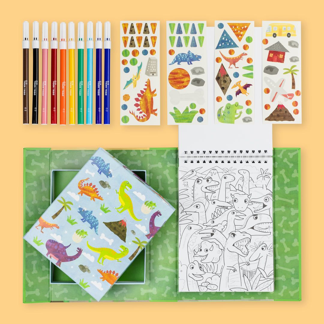 Coloring book, stickers, and pencils on a yellow background