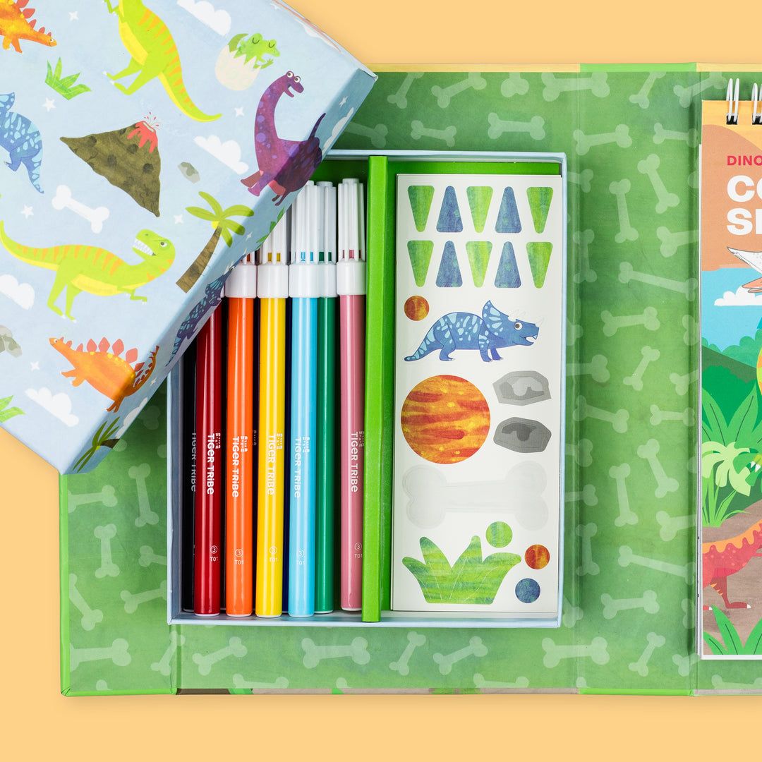 Coloring book set with colored pencils and stickers on a yellow background
