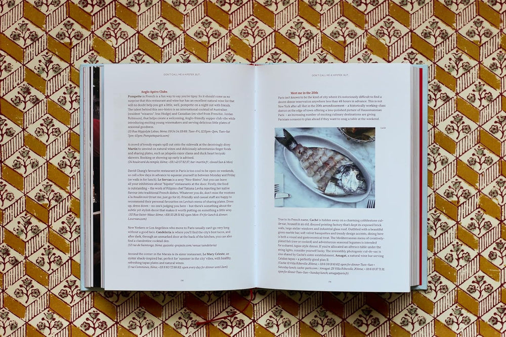 Open book on a patterned surface with text and an image of fish.